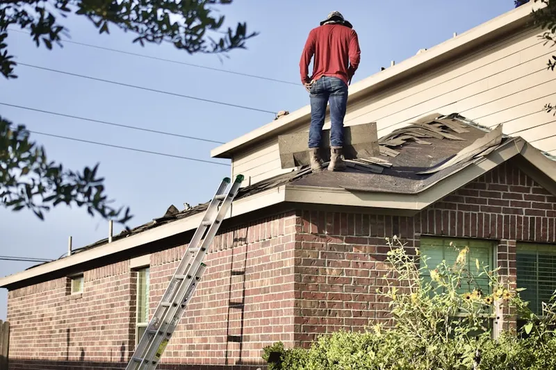 Professional roofer working on a residential roof in Marshalltown